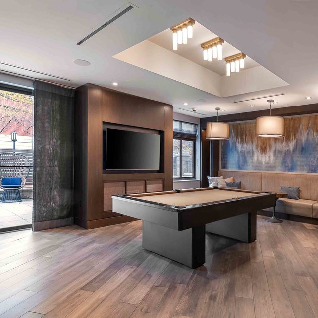 Instrata Pentagon City - Modern Game room with a Pool Table, TV, and Large Window