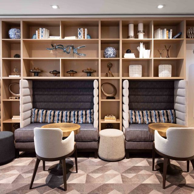 Instrata Pentagon City - Cozy Lounge Area with Ambient Lighting and Wooden Shelves