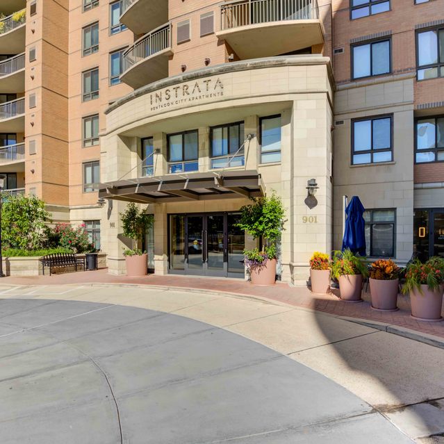 Instrata Pentagon City - Apartment Building Entrance with Potted Plants Lining the Entryway