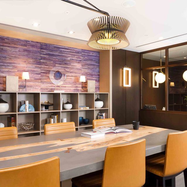 Instrata Pentagon City - Modern Meeting room with a Long Table, Cushioned Chairs, Pendant Lighting and Built-in Shelves
