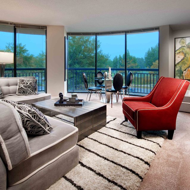 Instrata Pentagon City - Cozy Living Area with Floor-to-Ceiling Windows and Balcony Access