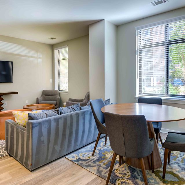 Instrata Pentagon City - Carpeted Living with a TV and Dining Area with Window